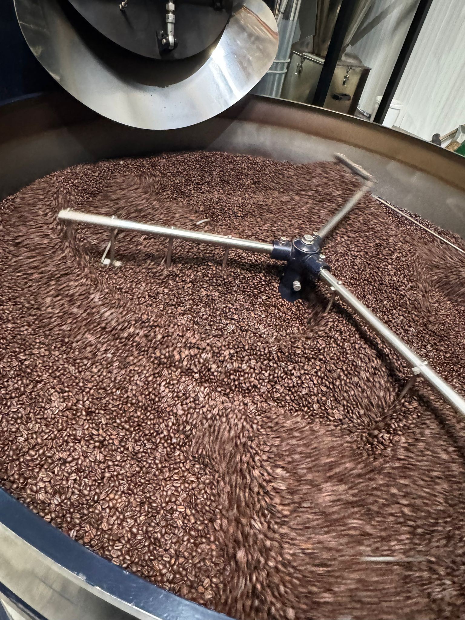 Frisch geröstete Kaffeebohnen während des Röstprozesses bei MEE Kaffee. Durch schonende handwerkliche Röstung entstehen intensive Aromen und ein vollmundiger Geschmack für höchste Kaffeequalität.